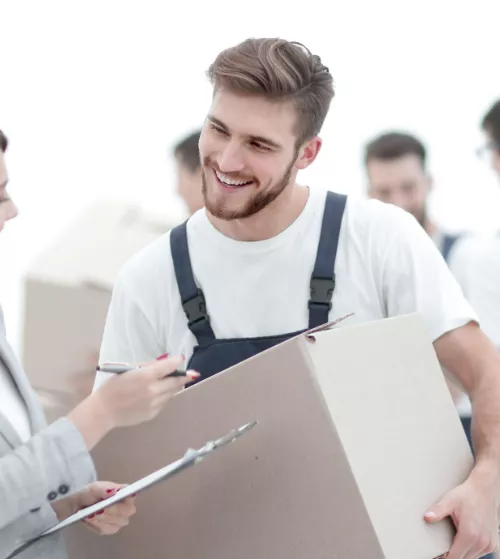 Mover holding a box and smiling